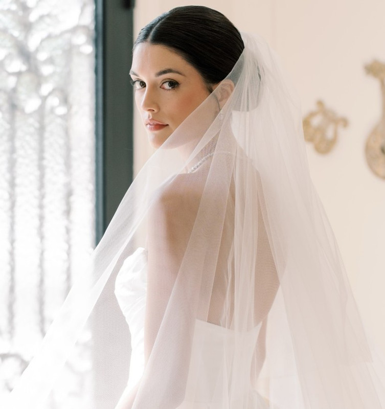 Bride with veil in contemplative pose