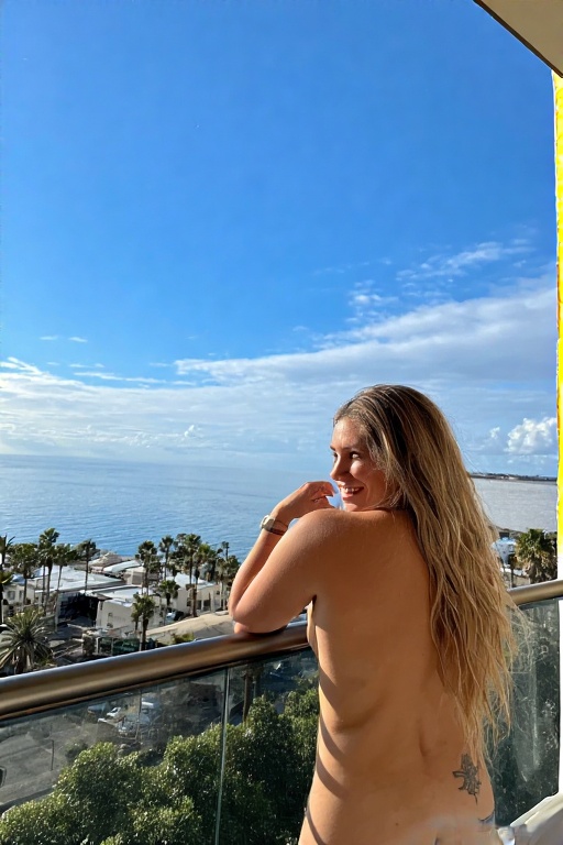 A-woman-stands-on-a-balcony-ov-17