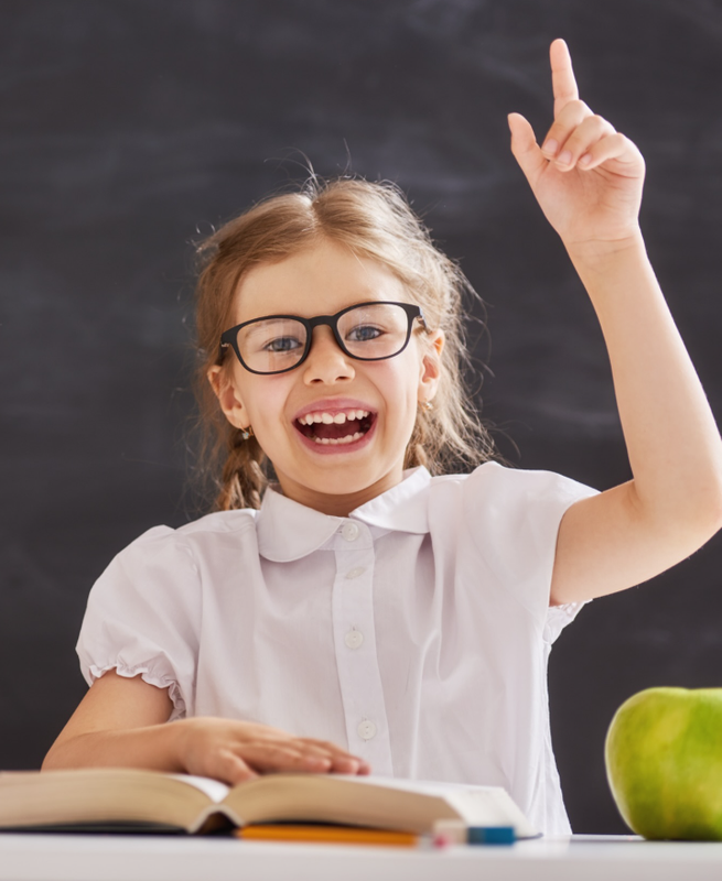 A Pre-K child raising their hand in class