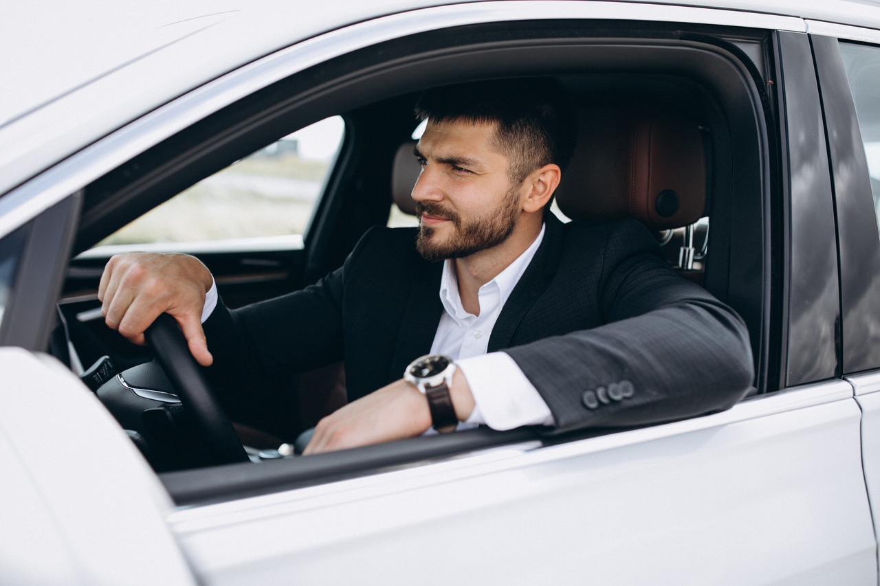 handsome business man travelling car