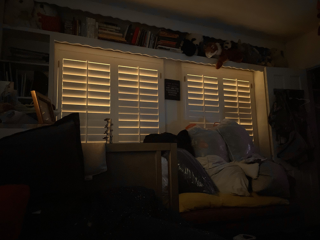 a photo of the orange light from the morning sky creeping through the cracks in my shutters, in my otherwise dark room