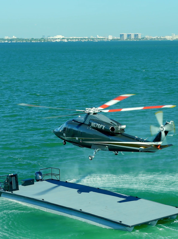 Helicopter flying low over ocean near Miami coastline