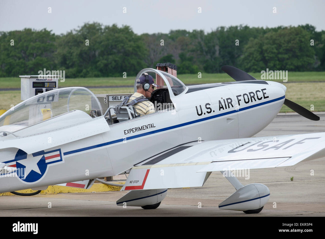 pilot-in-cockpit-with-open-canopy-of-small-airplane-preparing-for-EKR5P4
