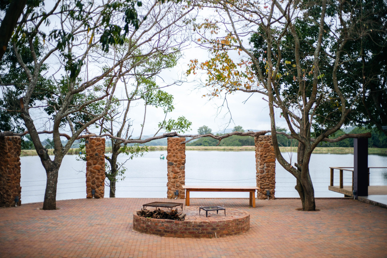 The Boma area at night, with a fire pit and seating, ready for an outdoor gathering.