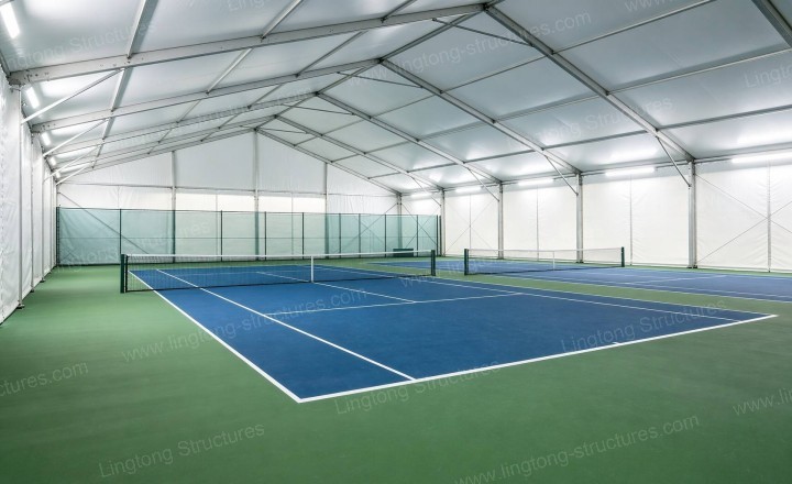 Players enjoying a game inside the Pickleball Tent with natural light