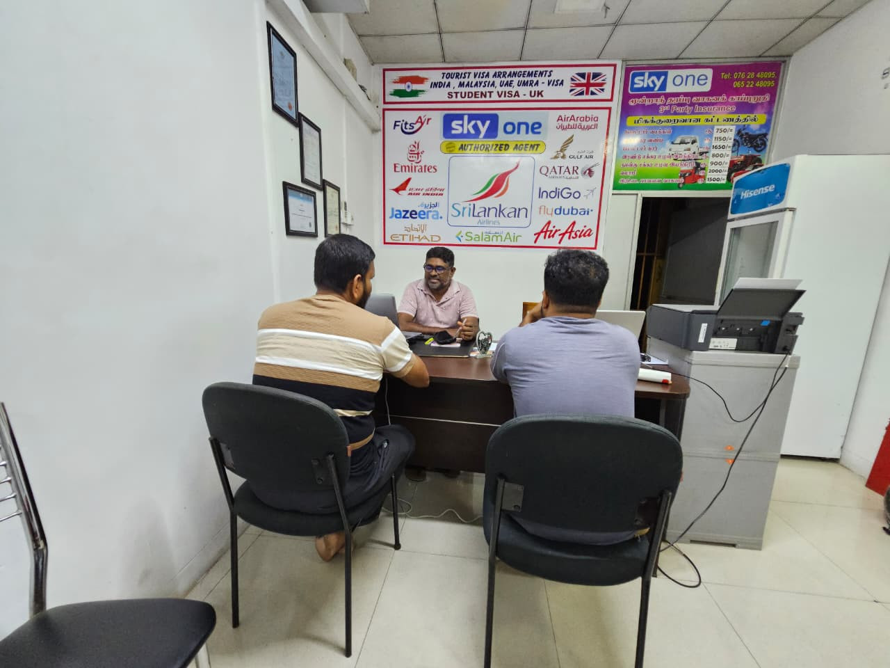Sky One team assisting customers at the office desk