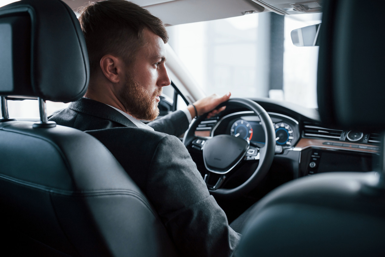 elegance beauty modern businessman trying his new car automobile salon