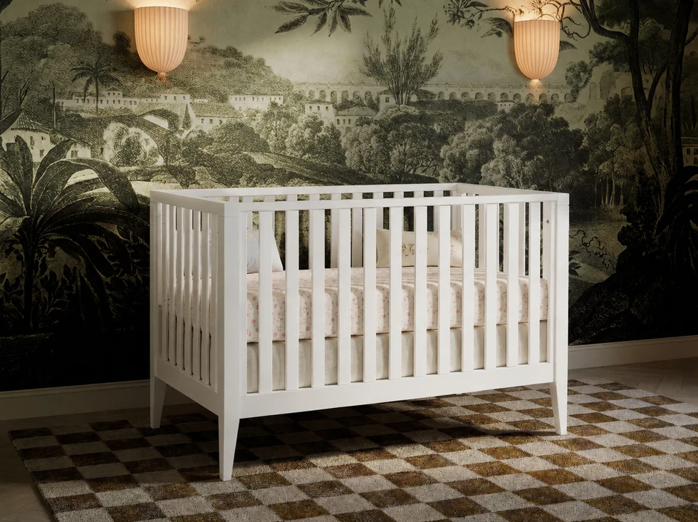 Wooden crib displayed as part of a coordinated nursery