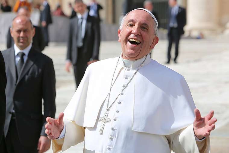 Pope_Francis_laughing_outside_of_St_Peters_Basilica_during_the_g