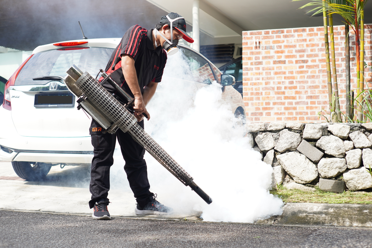 Technician performing outdoor fogging