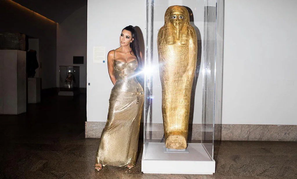 Kim Kardashian at the 2018 Met Gala near the gold sarcophagus of Nedjemankh