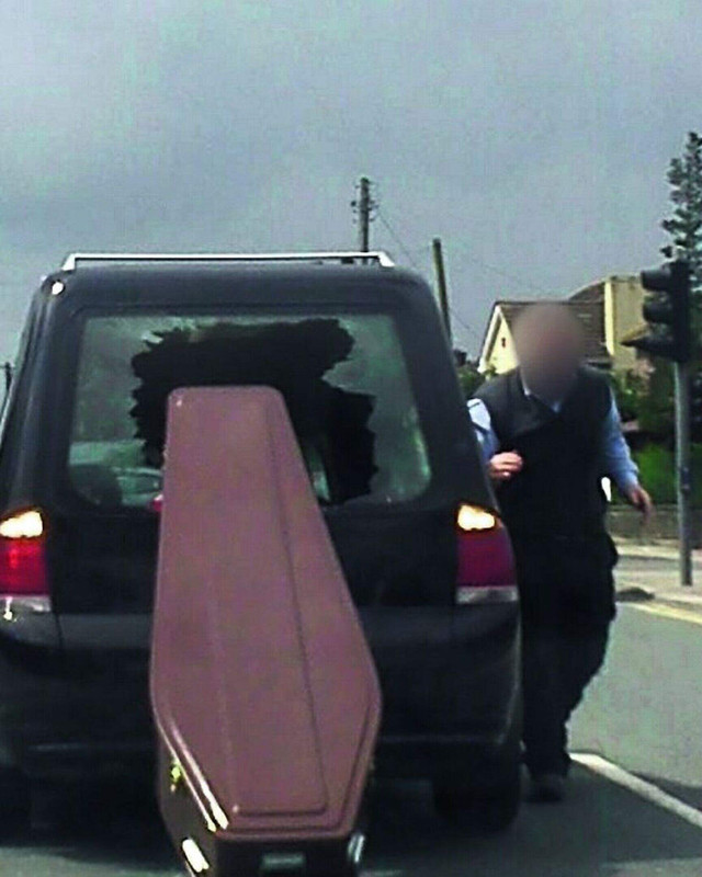 The picture taken by Sean Sullivan Smyth of the coffin crashing through the back of the hearse in Dr