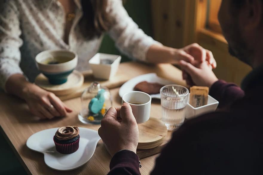 people-man-woman-couple-holding-hands-dinner-date-restaurant-coffeehouse.jpg