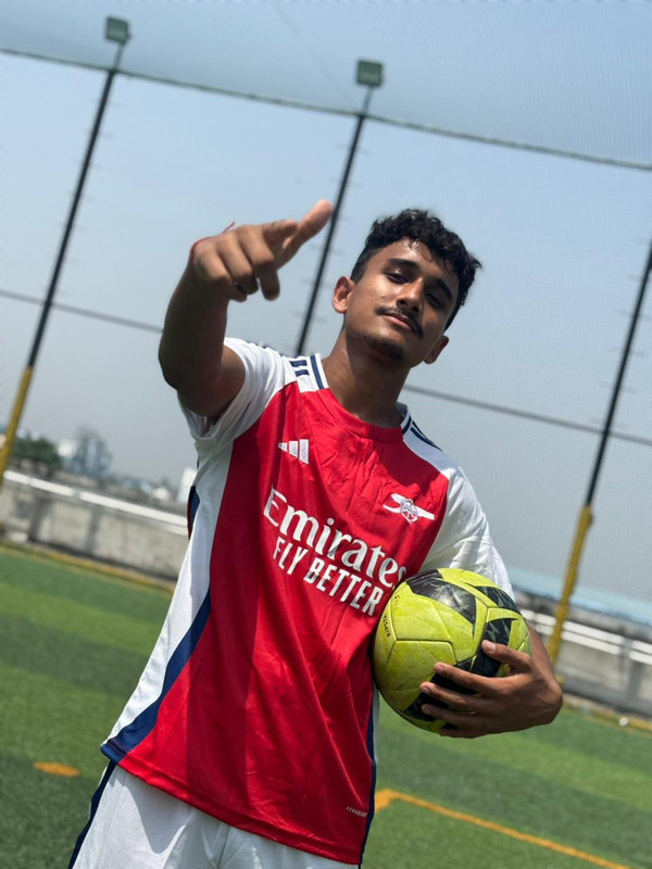 A goalkeeper diving to make a save in front of the goal.