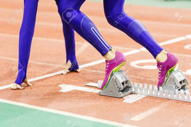 74990737-girl-standing-at-the-starting-blocks-before-sprint.jpg