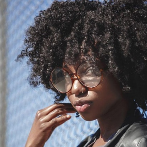 Pretty Black girl with curls and glasses as Face Claim for Thabi