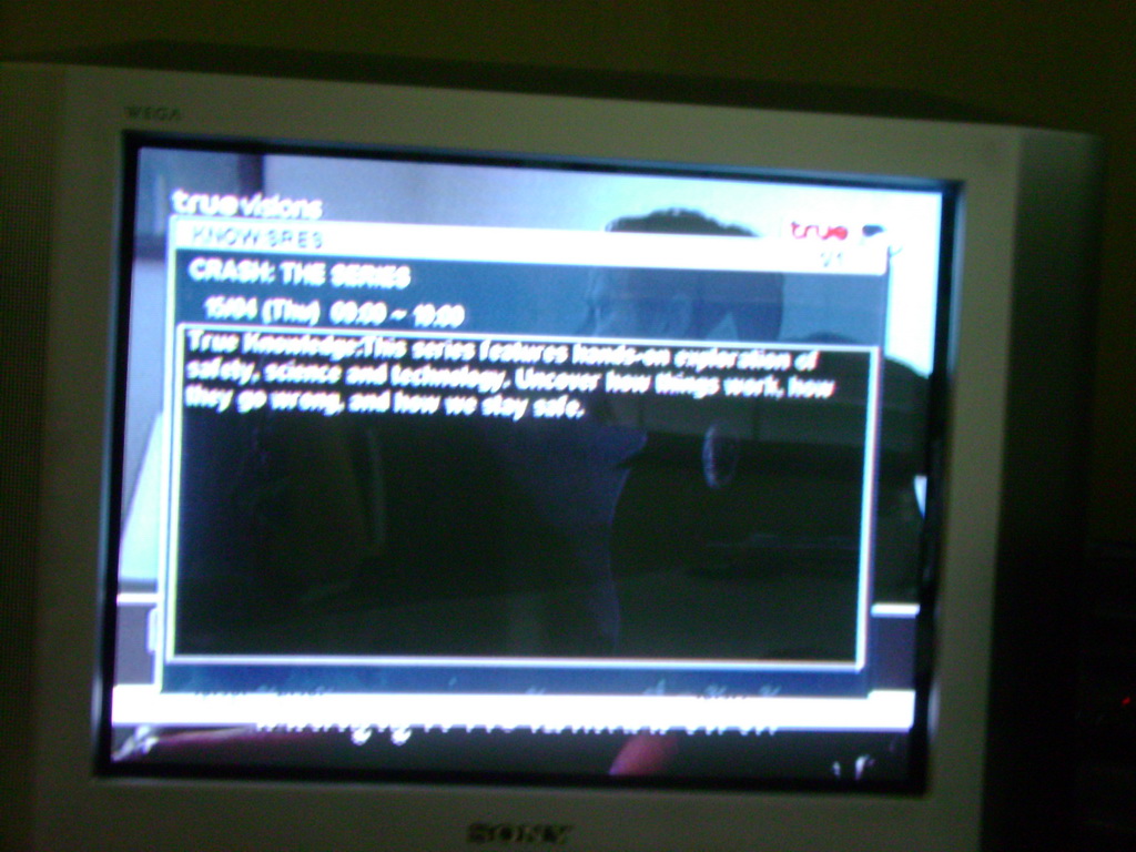 Full-screen EPG blurb for Crash The Series, over an airing of said show: 'This series features hands-on exploration of safety, science and technology. Uncover how things work, how they go wrong, and how we stay safe.'