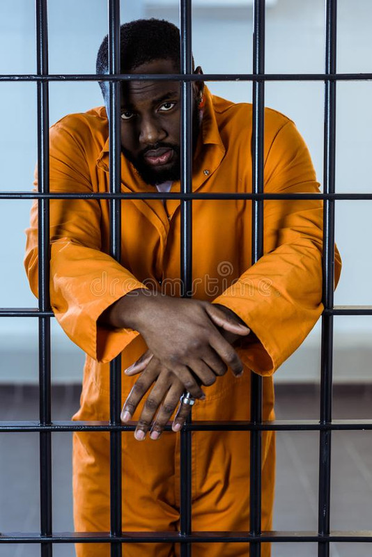 african-american-prisoner-uniform-standing-behind-prison-bars-african-american-prisoner-uniform-stan.jpg