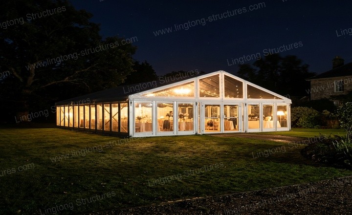 Guests enjoying a wine-tasting gala inside the marquee with festive lighting