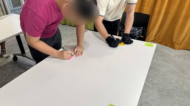 Participants writing on sticky notes during an activity