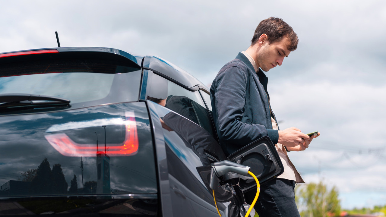 man-charging-his-electric-car-charge-station-using-smartphone-1