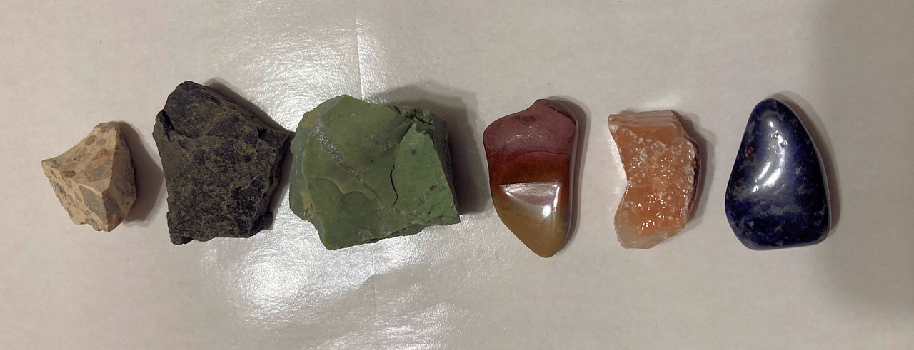 raw leopard jasper, raw black star moonstone, raw chrysoprase, tumbled desert jasper, raw red calcite, tumbled sodalite, mystery gift, 10ml eucalyptus Water, information sheet